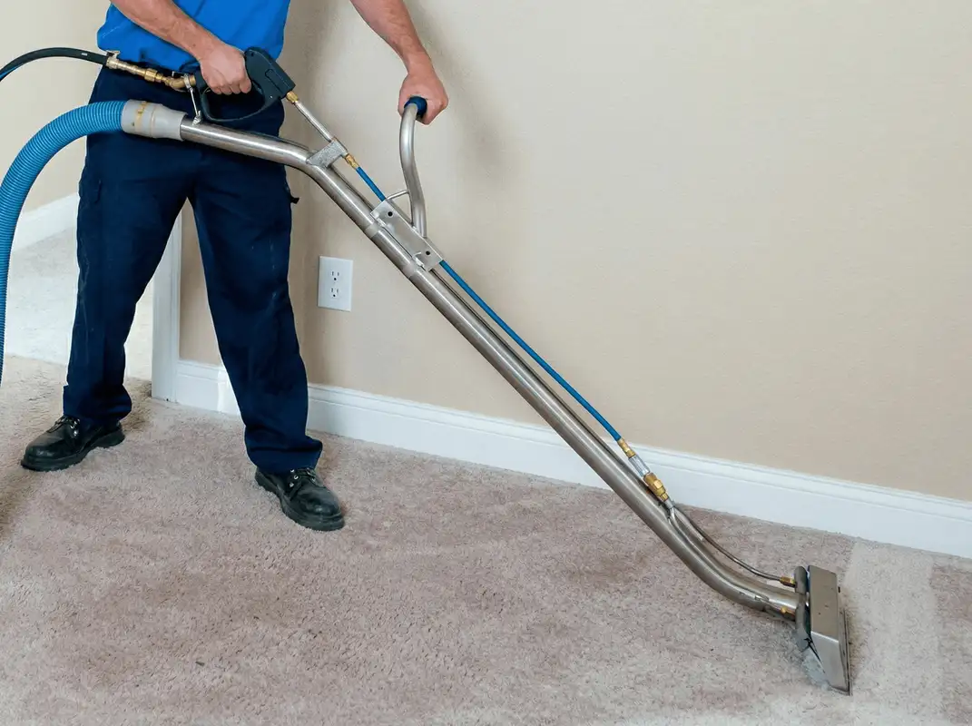 Professional operating a liquid removal machine on a carpeted floor in Pasadena, CA